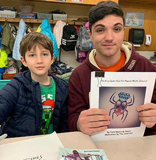 HS and 3rd grader sitting together in a classroom