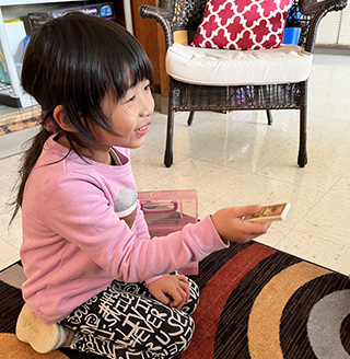 English learner sitting on the classroom carpet